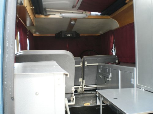 Interior showing new storage unit which contains space for the porta-potty, oil, tools and canned stuff.